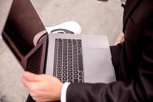 close-up of a laptop on a guy's lap photo