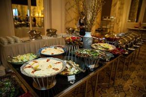 buffet table with various salads and snacks photo