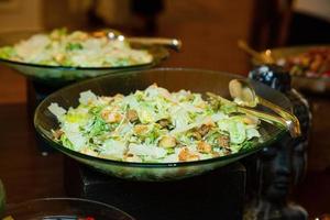 buffet table with various salads and snacks photo