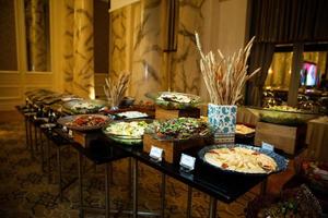 buffet table with various salads and snacks photo