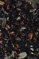 Black tea close-up. Dry tea with spices for brewing. photo