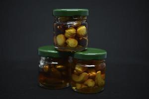 Glass jars with nuts in honey. Delicious sweets. Nuts in honey. Sweet nuts. photo