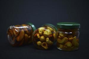 Glass jars with nuts in honey. Delicious sweets. Nuts in honey. Sweet nuts. photo