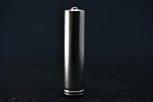 A shiny electric battery on a black background. The battery is a close-up. photo