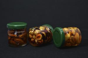 Glass jars with nuts in honey. Delicious sweets. Nuts in honey. Sweet nuts. photo