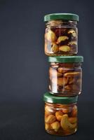 Glass jars with nuts in honey. Delicious sweets. Nuts in honey. Sweet nuts. photo
