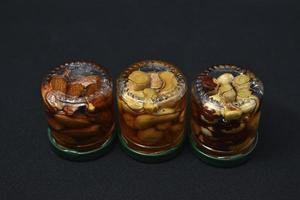 Glass jars with nuts in honey. Delicious sweets. Nuts in honey. Sweet nuts. photo