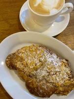 Croissant with almonds and cappuccino. photo