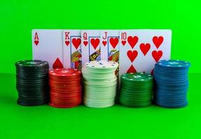 Poker chips in stacks and royal flush on the table. photo