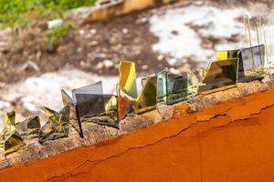 Dangerous wall with broken glass shards Playa del Carmen Mexico. photo