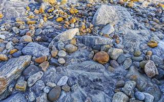 Beautiful rock cliff stone boulder texture pattern beach in Mexico. photo