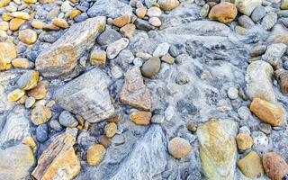 Beautiful rock cliff stone boulder texture pattern beach in Mexico. photo