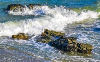 Beautiful rocks cliffs surfer waves at beach Puerto Escondido Mexico. photo