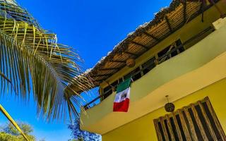 Hotels resorts buildings in paradise among palm trees Puerto Escondido. photo