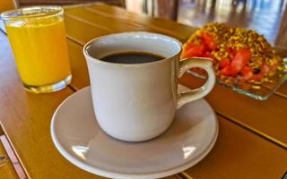 Breakfast at restaurant fruits with oatmeal orange juice and coffee. photo