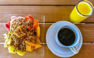 Breakfast at restaurant fruits with oatmeal orange juice and coffee. photo