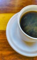 Cup of americano black coffee in restaurant Mexico. photo