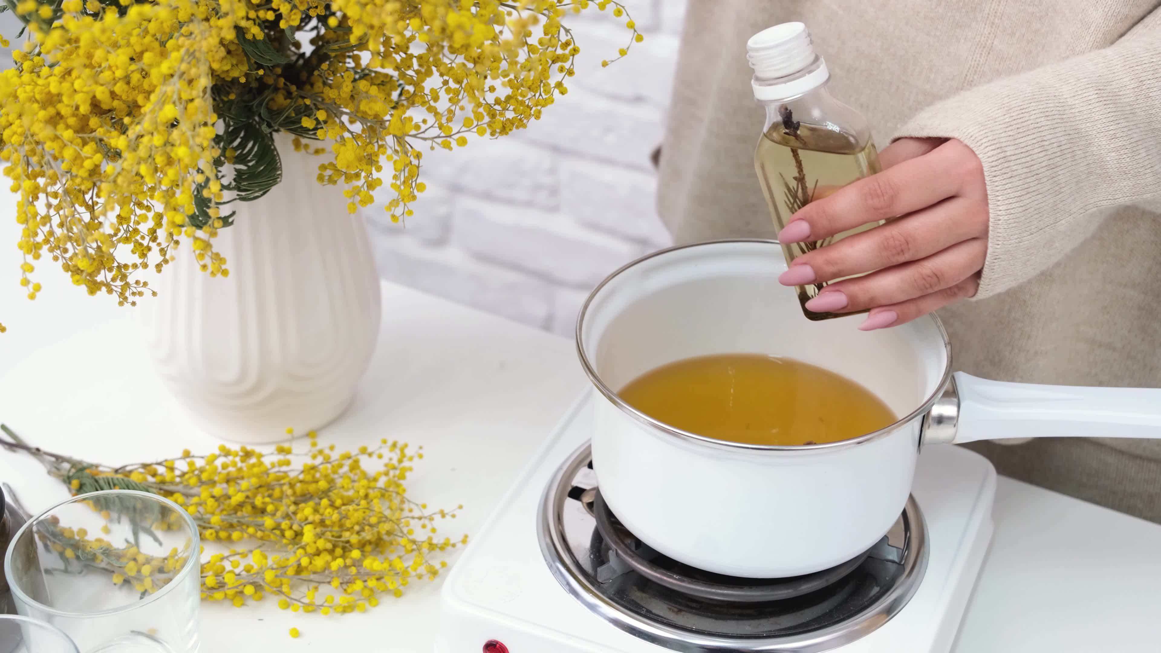woman making candles, melting soy wax in the pot 20877753 Stock Video