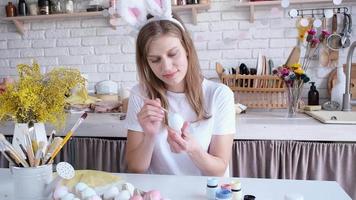 closeup of woman hands painting easter eggs with pastel colors for holiday, hello spring concept, easter preparation concept video