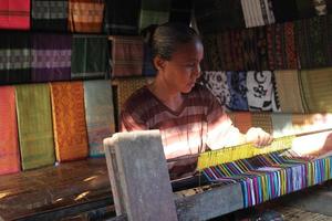 Lombok, Indonesia - August, 2014. women craftswomen of traditional woven fabrics in Lombok, Indonesia photo