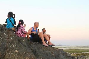 Lombok, Indonesia - August, 2014. tourists and local children playing together on the beach photo