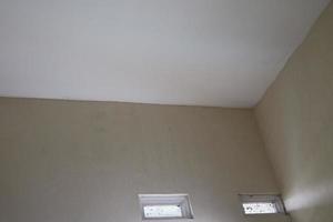 a corner of the wall of a room with white paint photo