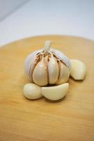 Garlic and garlic cloves on a wooden chopping board. Garlic product photo in photo studio. portraits.