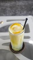 Ice squeezed orange or orange juice in a tall glass at the table photo