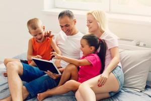 Family looking at laptop and laughing photo