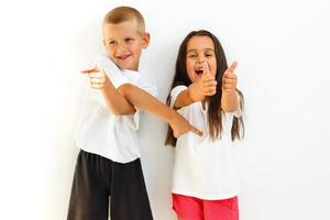 A portrait of a laughing girl and a smiling boy on the white background photo