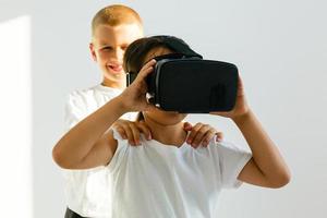 Selective view of two little children using virtual reality headsets photo