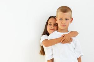 Teens brother and sister. The concept of a happy childhood, beauty, people, fashion, healthy lifestyle. Isolated on white background. photo