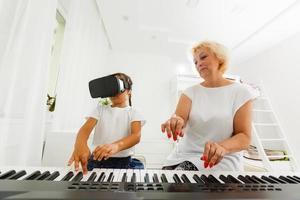 Music teacher shows how to play the piano photo