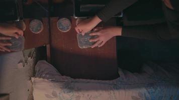 a Muslim woman is cleaning up make up equipment in front of her brown dressing table in a room video