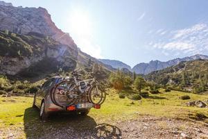 cars with bicycles in the mountains photo