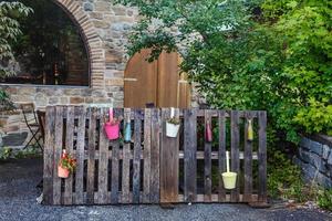 decor from flowerpots on the fence photo