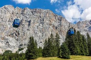 Ski lift in summer. Cable car. View from the mountain. Beautiful landscape. Ski track in summer. Funicular. Mountainous terrain. photo