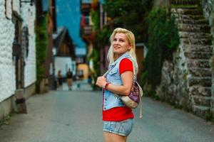 woman tourist walking on the street, summer fashion style, travel to Europe photo