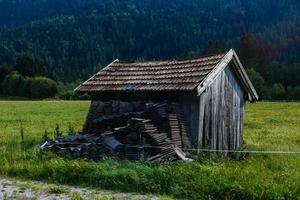 One wooden house in the fall on a hill in the mountains. photo