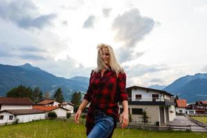woman enjoying beauty of nature looking at mountain. Adventure travel, Europe. Woman stands on background with Alps. photo