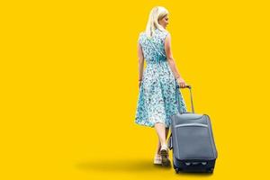 girl a suitcase on a yellow background photo
