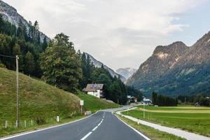 Road turning in the mountains, Alps background photo