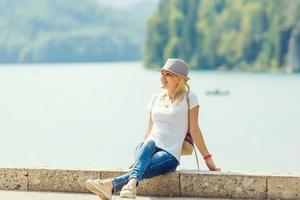 Rest on a mountain lake near Neuschwanstein. girl is sitting, enjoying a rest in the middle of the alpine mountains photo