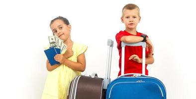 Siblings travelling - boy and girl holding money, passports, and suitcases. Isolated, white background photo