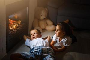 happy children with magic at home near fireplace photo