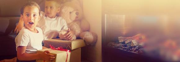 Adorable little girl opening a magical gift in cozy living room photo