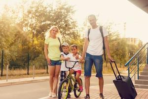 Happy family with suitcases photo