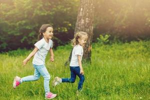 Happy children running around outside playing catch-up concept photo