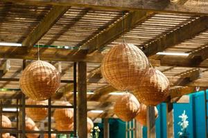 Interior of the outdoor terrace with a wicker wood ceiling lamp. photo