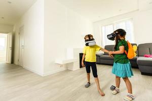 Child with virtual reality headset and joystick playing video games photo